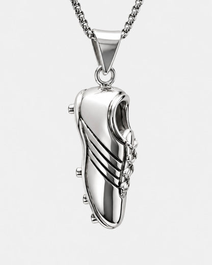 Silver shoe-shaped pendant on a chain against a white background