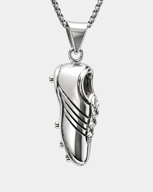 Silver shoe-shaped pendant on a chain against a white background