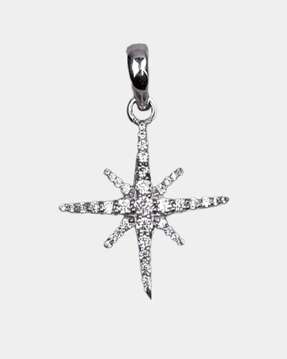 Star-shaped silver pendant with clear stones on a light gray background