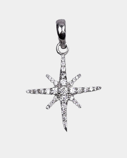 Star-shaped silver pendant with clear stones on a light gray background